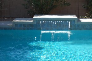 Pool with shear decent waterfall.