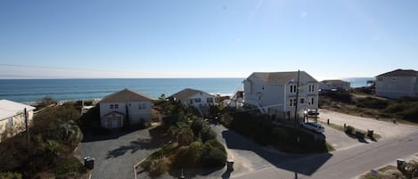 See the edge of deck railing in lower right and beach access across street