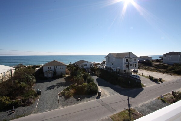 See the edge of deck railing in lower right and beach access across street