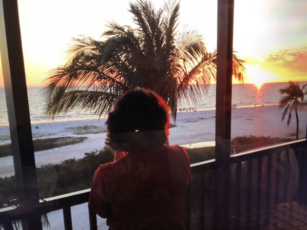 My wife's Gulf Sunset view from the condo unit private screen porch 