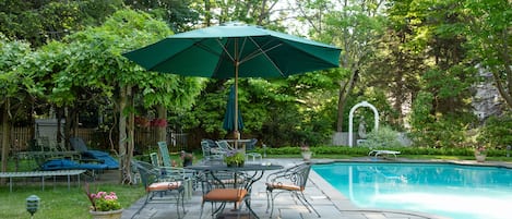 Seating by the Grecian pool-- Under the wisteria/grape arbor and around tables 