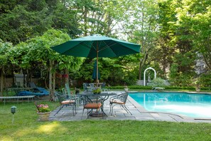 Seating by the Grecian pool-- Under the wisteria/grape arbor and around tables 