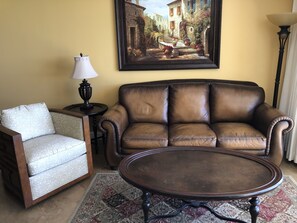 Living area with a leather queen sleeper sofa.