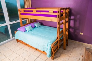 Second bedroom with twin-full-twin bunk beds and air conditioner