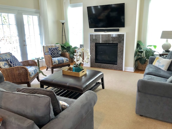 The living area has a large HDTV with stereo sound and a fireplace.