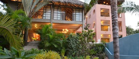 View of the house and its garden at dusk