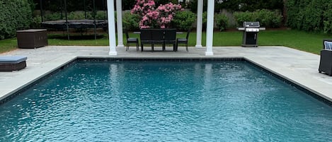 Gunite custom pool with landscaping and covered dining. Viking outdoor grill