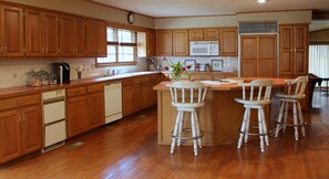 Well-appointed kitchen stocked with pots, pans, and dishes.