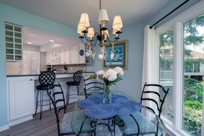 Two counter stools buffer the dining are from the kitchen
