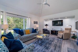 The great room has floor to ceiling windows which let in loads of light