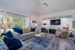 The great room has floor to ceiling windows which let in loads of light