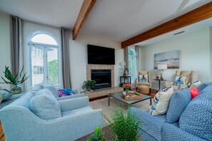 Beautiful wood beams and ceiling fans run through the main living area.