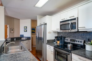 Even the most discerning chef will be impressed with this kitchen.  Stainless steel appliances, white cabinets,