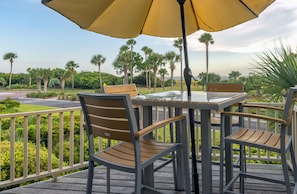 The deck overlooks the ocean, beach, and Deveaux Banks across the waters.