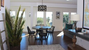 The lower level family room is surrounded by windows with beach views.