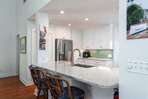 Additional stools at the breakfast bar between the dining room and kitchen