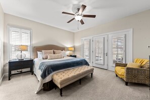 The master bedroom en-suite has a king bed and access to the screened porch.
