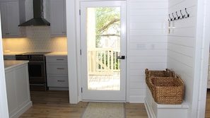 Shiplap paneling and a bench create a welcoming entry.