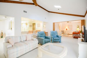 Cozy living room of this villa in New Smyrna Beach with 2 leather recliner, couch and love seat.