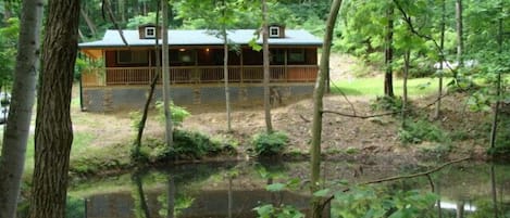 Hickory Grove Cabin overlooks it's own fishing pond on 8 private acres.