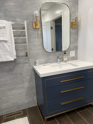 Newly renovated shower on the second floor with a warmer towel rack 