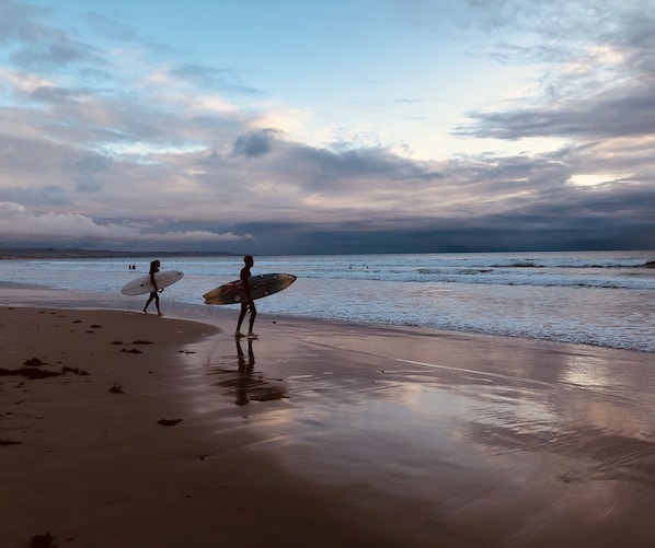 Surfing at dusk on a beautiful autumn day at Moana Beach - a 2 minute walk