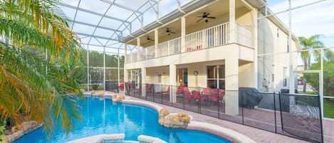 Pool area with plenty of seating and a safety fence.