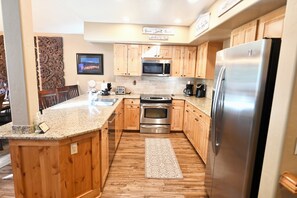 Bright open fully stocked kitchen with plenty of counter and cupboard space!