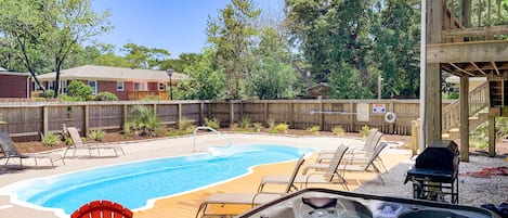 Fenced-in backyard w/ salt water pool, hot tub, grill, lots of seating/lounging