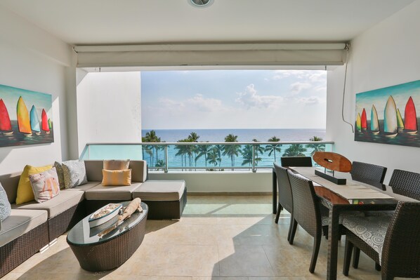 Balcony with beach front view and dinning table for 6.