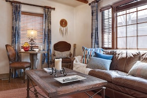 Living room with queen size sofa bed and kiva fireplace.