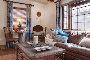 Living room with queen size sofa bed and kiva fireplace.
