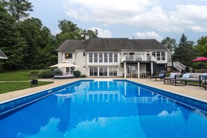 Backyard of the property. Large pool & plenty of seating for everyone 