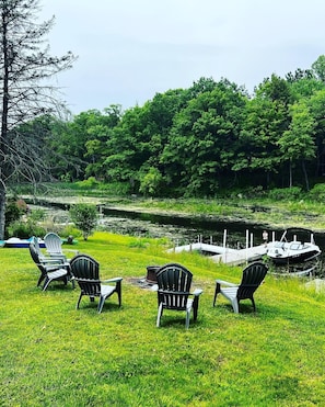 View of backyard fire pit and docks.