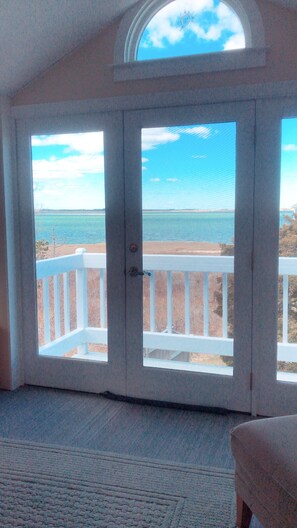 A view of the inside looking at the ocean during the fall season.