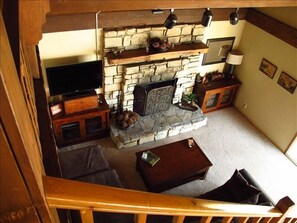 Living room with Flat-screen, DirecTV, DVD, fireplace and sectional couch.