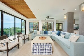 Living Room - Spacious and bright, the living room offers plenty of seating for the whole family, with the added space of the large balcony, where you can gaze out at the ocean.