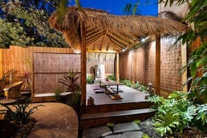Gazebo with BBQ behind screened area