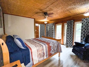 Downstairs Bedroom Queen Bed with French Doors opening to the patio deck.