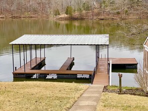 Two-slip, covered boat dock with power (both slips available) & a swim deck