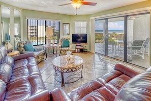 Living Room - Spacious living room with open floor plan and connected balcony featuring a direct view of the ocean.