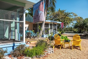 the Ibis cottage exterior lanai and adirondack chairs.