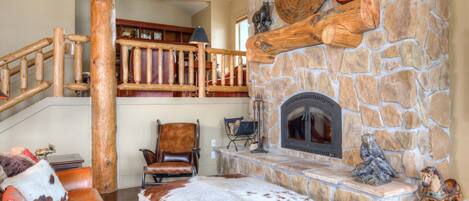 Cozy up in front of the stone fireplace in the living room