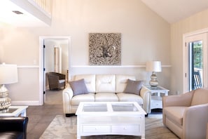 Living room with beautiful custom carpet and leather furniture