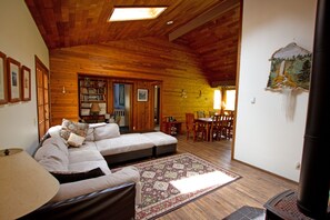 As you walk into the home, you notice cedar ceilings, oak floors, pine walls....