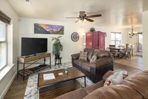 Newly furnished living room with comfortable sofas and TV