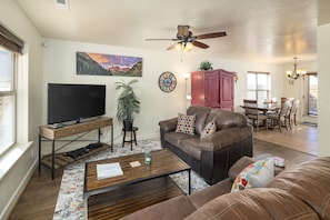 Newly furnished living room with comfortable sofas and TV