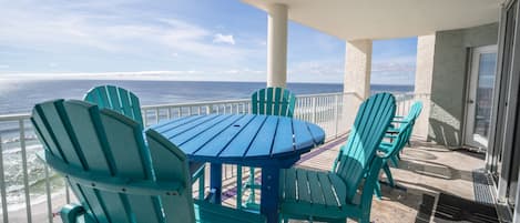 Oversize balcony with bistro table and high top chairs; 3 other chairs side tabl