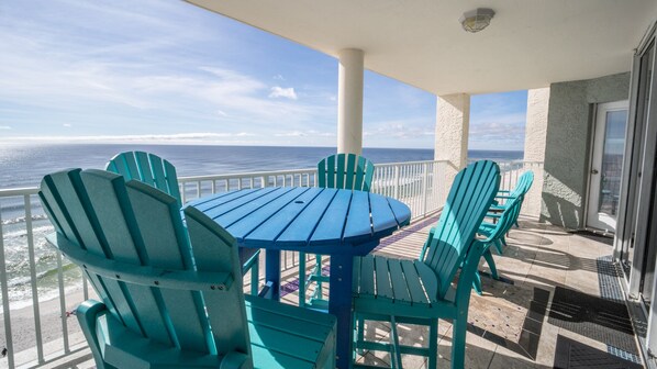 Oversize balcony with bistro table and high top chairs; 3 other chairs side tabl