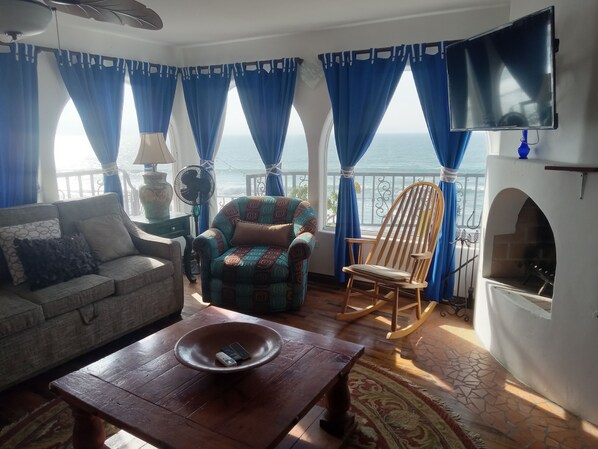 Living room with fireplace & ocean views